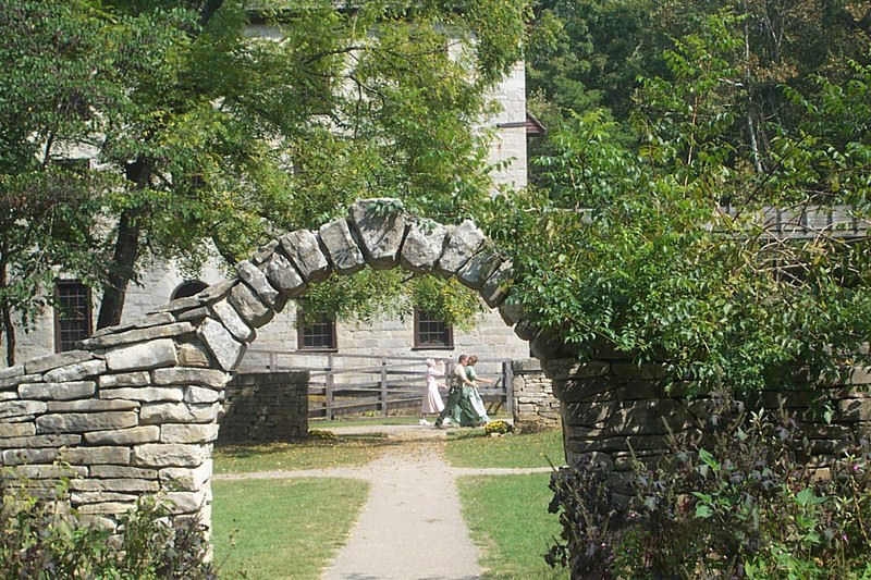 Amish family members walking through Spring Mill village
